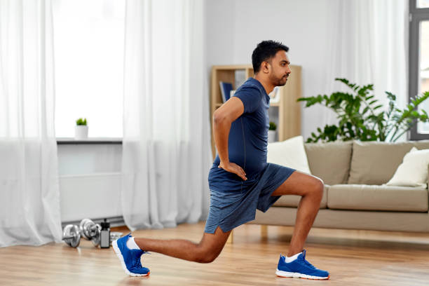 indian man exercising and doing lunge at home fitness, sport and healthy lifestyle concept - indian man exercising and doing lunge at home lunge stock pictures, royalty-free photos & images