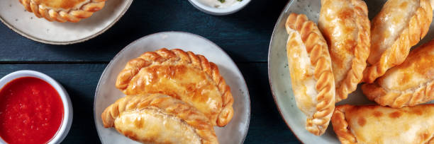 istock Empanadas dinner panorama on a dark rustic wooden background 1302210845