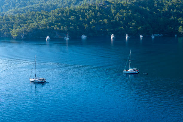 Coves and cliffs in the Mediterranean Sea. Kekova, Turkey. Yachts or boats sailing on the sea