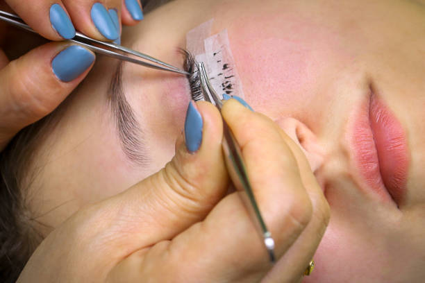 istock Eyelash extension procedure, woman eye with Long eyelashes 1302214275