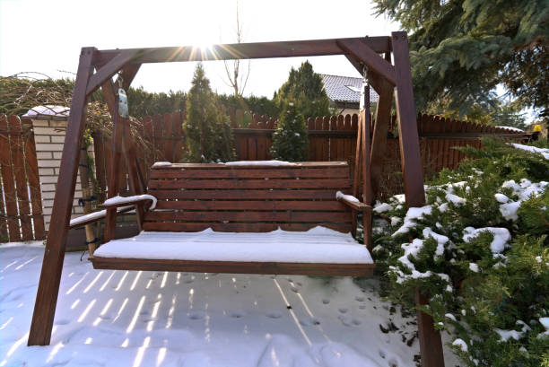 wooden swing covered with snow