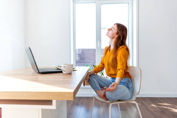 istock Defocus. Young business woman is meditating after work the Internet using a computer. 1302218438