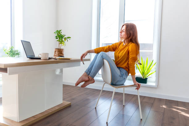 istock Defocus. Young business woman is meditating after work the Internet using a computer. 1302218464