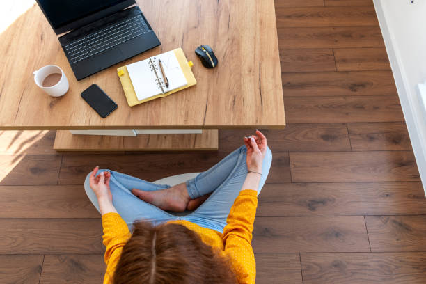 istock Defocus. Young business woman is meditating after work the Internet using a computer. 1302218473