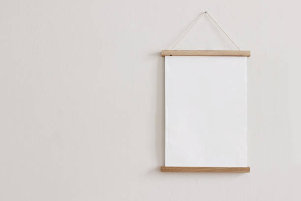 istock Blank wooden picture frame hanging on beige wall. Empty poster mockup for art display. Minimal interior design.Front view, copy space. No people. 1302218948