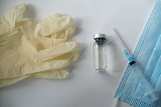 istock vials with infection vaccine, syringe, protective mask 1302219887
