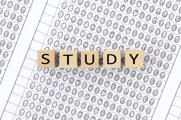 istock Wooden blocks with STUDY words on mark sheet 1302219983