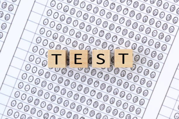 istock Wooden blocks with TEST words on mark sheet 1302220021