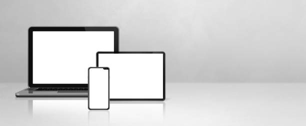 istock Laptop, mobile phone and digital tablet pc on white concrete office desk. Banner background 1302223759