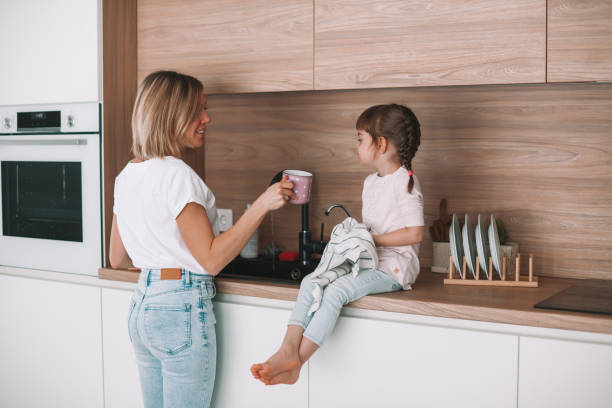 istock Little girl helping her mother 1302224545