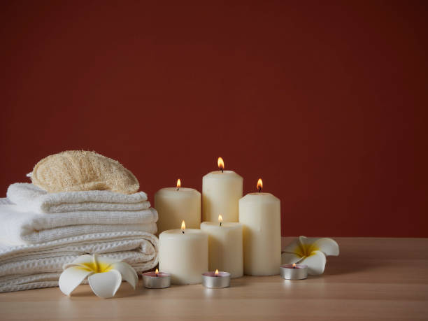istock Beautiful spa composition with burning scented candles and flowers on table 1302224598