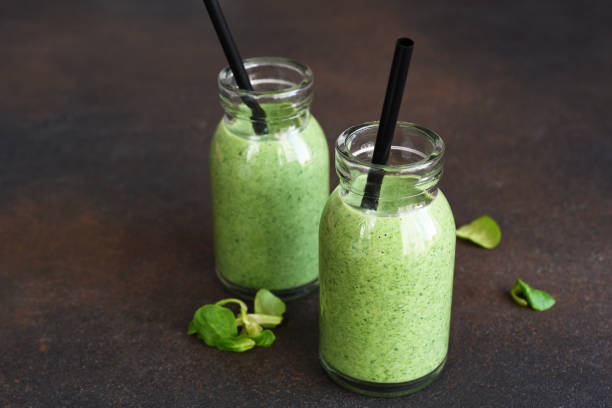 istock Detox menu. Vegetable smoothie with spinach on a dark concrete background in a jar. 1302226216