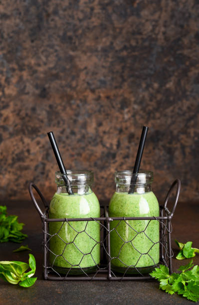 istock Detox menu. Vegetable smoothie with spinach on a dark concrete background in a jar. 1302226218