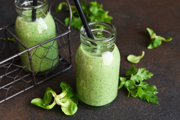 istock Detox menu. Vegetable smoothie with spinach on a dark concrete background in a jar. 1302226246