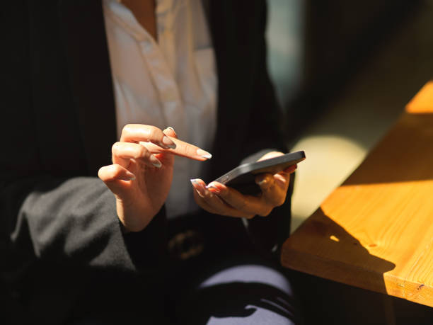 istock Female texting on smartphone in her hand while relaxed sitting in cafeteria 1302227452