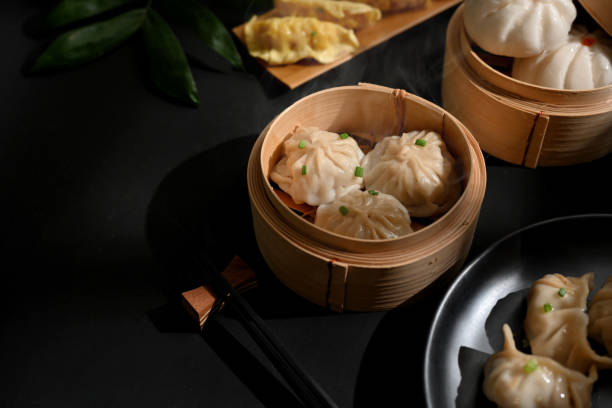 istock Dimsum dumplings on bamboo steamer on dinning table in Chinese restaurant 1302227703