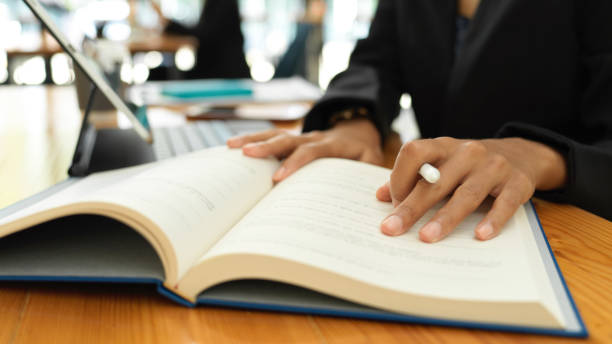 istock Female student reading textbook to prepare for her coming exam 1302227945