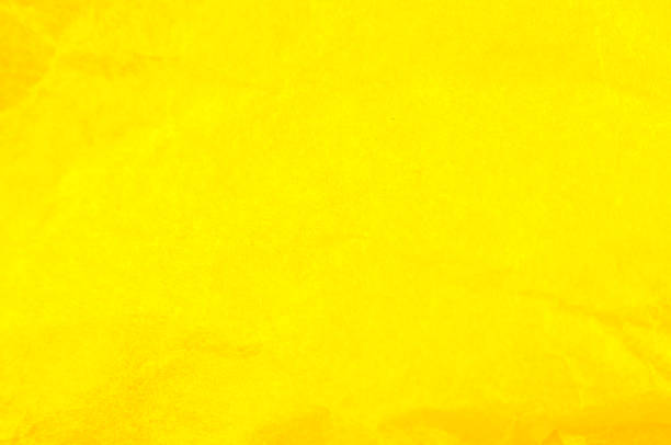 istock Crumpled yellow paper background. Real macro battered texture. Close up photo. 1302228097