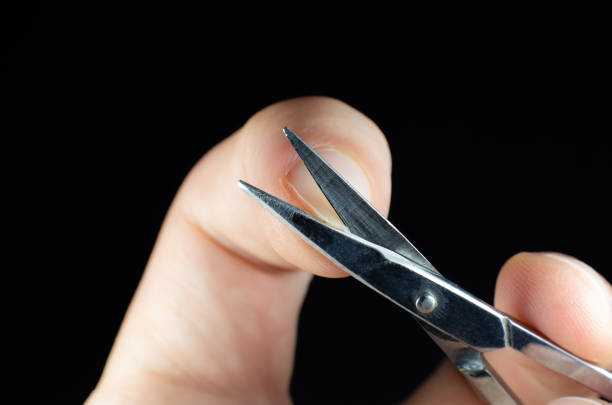 istock Man is making a manicure scissors. Procedures at home. Cutting nails. 1302228250