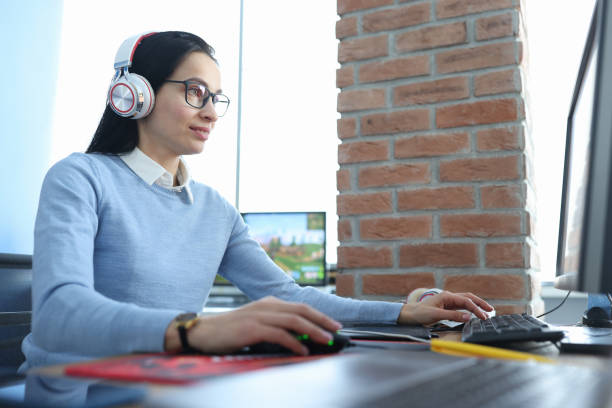 istock Young woman in headphones working at computer 1302230850