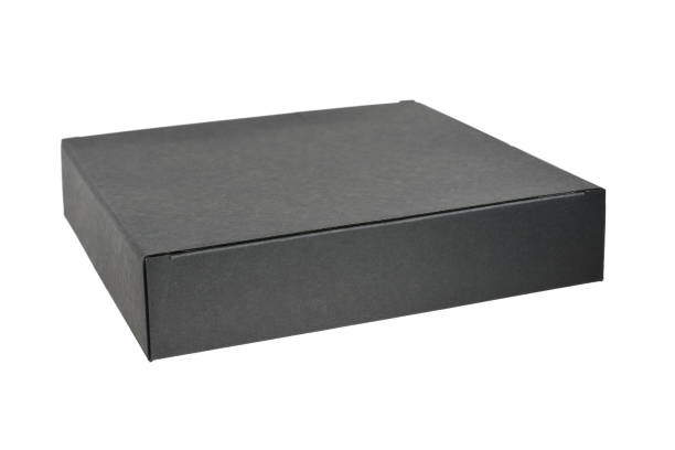 istock Paper cardboard gift box in black color on white background, close-up 1302232029