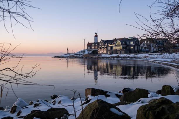 istock snow covered beach during wnter by Urk lighthouse in the Netherlands 1302233410