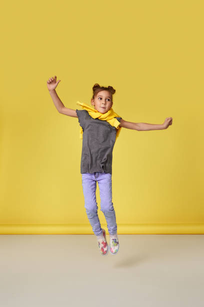 istock cute little child girl jumping 1302234568