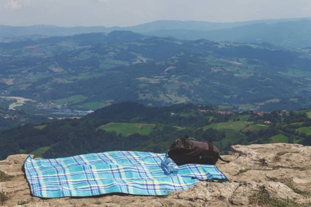 istock A towel and a backpack on a background of mountains. 1302234582