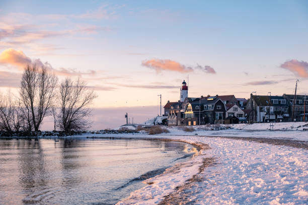 istock snow covered beach during wnter by Urk lighthouse in the Netherlands 1302234835
