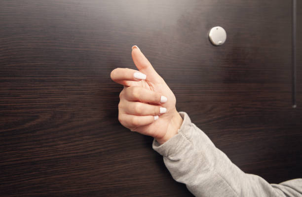 istock Female hand is knocking on the door. 1302234934
