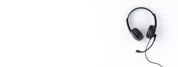 istock Call center concept. Helpdesk headset on white desktop with copyspace. Banner 1302235082