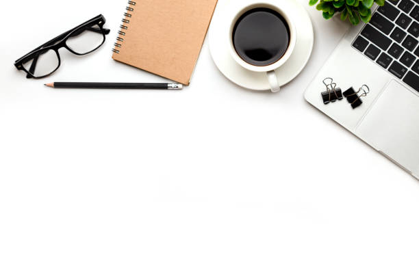 istock Flat lay, top view office table desk. Workspace with blank Laptop, office supplies, pencil, green leaf, and coffee cup on white background. 1302235364