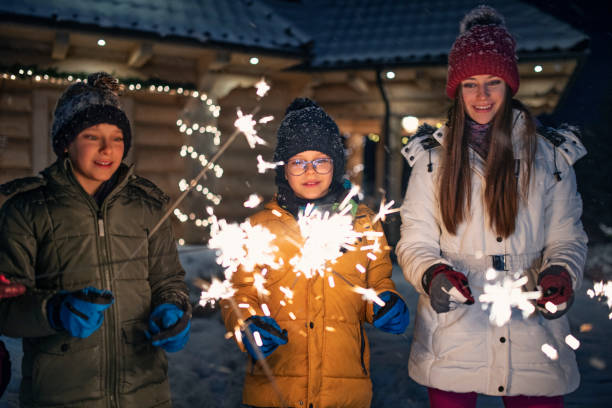 istock Children enjoying sparklers at winter night 1302238632