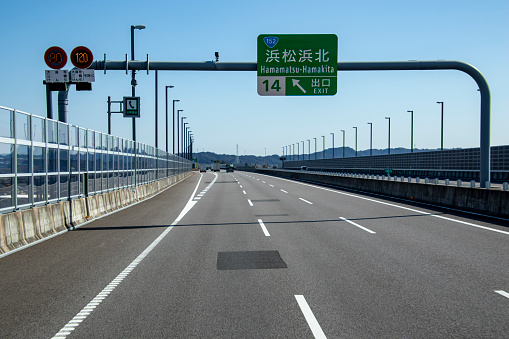 Daytime close-up of a blue roadsign on German Autobahn A3 near Frankfurt airport, directing to the interchange at Wiesbaden, the 'Wiesbadener Kreuz'