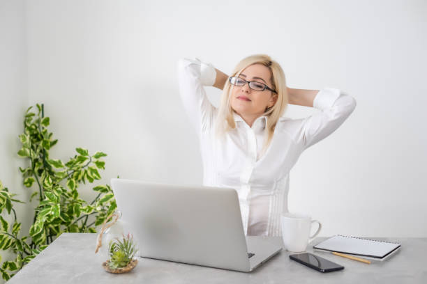 istock Beautiful young woman working on her laptop in her office. 1302243010