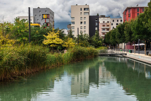 Water Garden de Bonne Eco District Grenoble, France - august 18, 2018. Water garden in sustainable complex, de Bonne Eco District. Eco-friendly living quarter with garden, boutiques and shops was built circling old military barracks. auvergne rhône alpes stock pictures, royalty-free photos & images