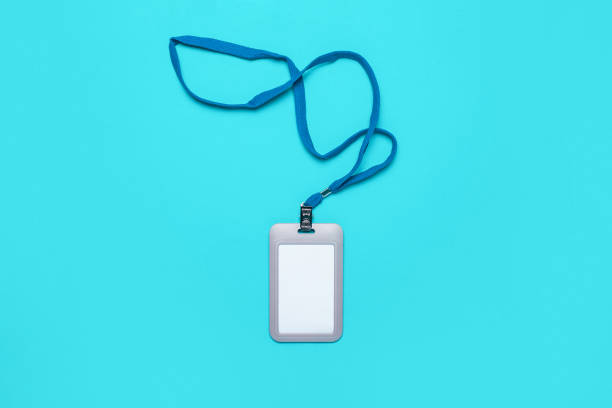 istock Blank badge with drawstring on a light blue background. Mock badge, name tag. Top view, flay lay. 1302243475