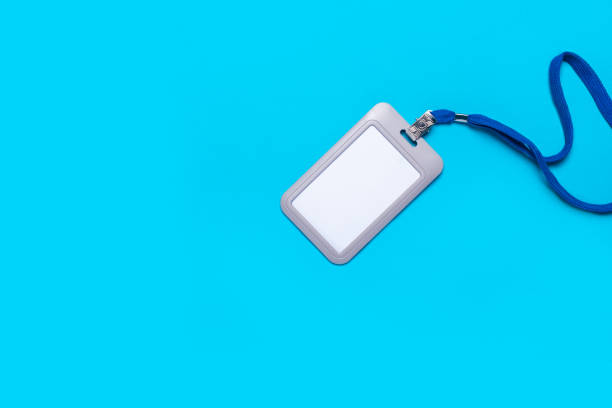istock Blank badge with drawstring on a light blue background. Mock badge, name tag. Top view, flay lay. 1302244521