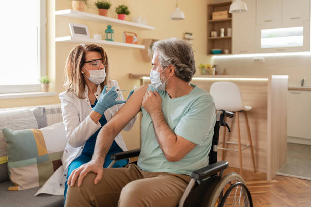 istock Doctor Giving Injection to Disabled Man 1302248501