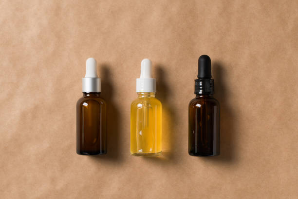 istock Serum bottles natural organic cosmetic with green leaf on brown 1302248559