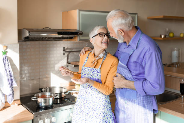 istock Love Never Grows Old. Older Couple is Enjoying at Home while Preparing a Delicious Meal. 1302248633