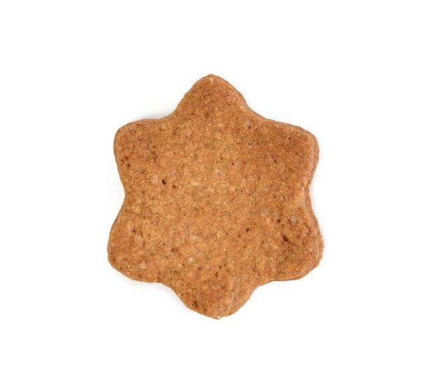 istock Star shaped baked chocolate gingerbread cookie isolated on white background 1302249368