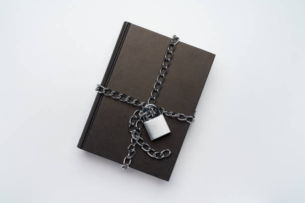 Hardback book and padlock on white background Hardback book and padlock on white background diary lock book cover book stock pictures, royalty-free photos & images