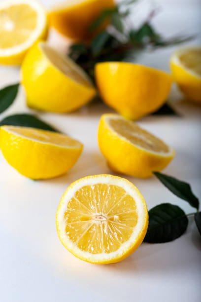 Fresh lemon slices with leaf on white background. Fresh lemon slices with leaf on white background. vibrant color lifestyles vertical close up stock pictures, royalty-free photos & images