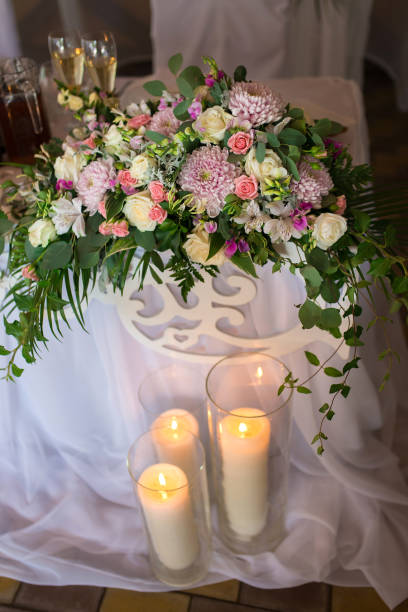 istock Floral arrangement for wedding table with candles 1302250279