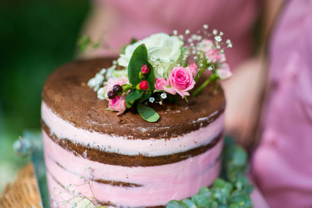 Rustic wedding cake decorated with fresh flowers