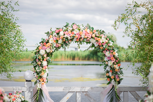 Wedding arch made of fresh flowers for the ceremony