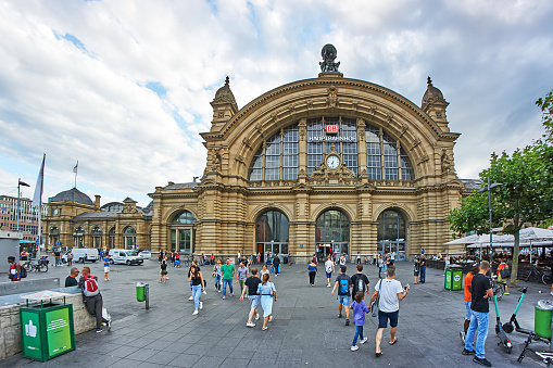 Frankfurt, Germany - July 6, 2019: Pedestrians in front of the Frankfurt station building.