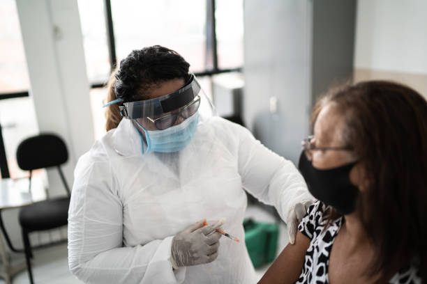 istock Senior woman being vaccinated wearing face mask 1302253479