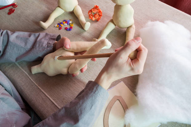 istock Creating textile toys. Assembling the doll body. 1302254482